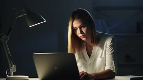 Young Woman Working On Laptop Late at Night