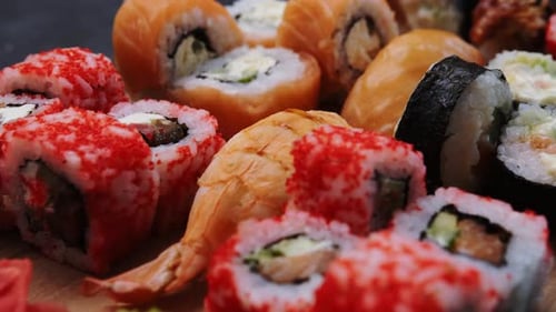 Assorted Sushi Rolls close-up on a Wooden Board