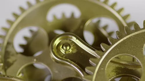 Rotating Gold Colored Gears Interlocking