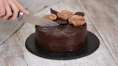 Woman Cutting a Delicious Chocolate Prague Cake