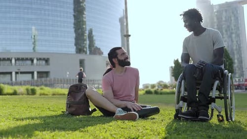 Happy friends with physical disability having fun outdoor at city park