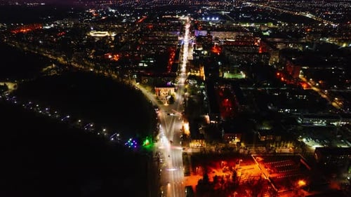 Night City View of Long Roads with Traffic and Buildings
