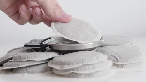 Coffee Pads being Placed into Coffee Pod Holder
