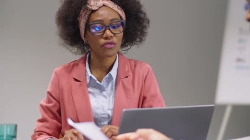 Business Professionals Collaborating on Project in Modern Office