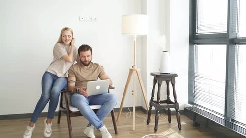 Young Couple Using Laptop at Home Together