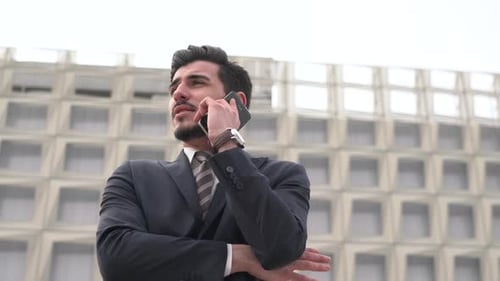 Young Businessman Talking on the Phone Outdoors