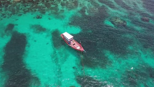 Boats Anchoring in Turquoise Shallow Water By the Edge of Coral Reef. Aerial View