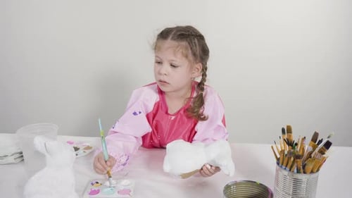 Little Girl Painting Paper Mache Figurine at Homeschooling Art Class