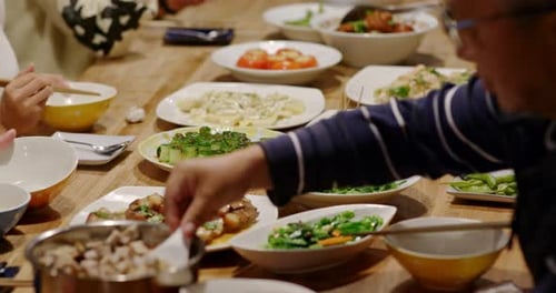 Friends Sharing Diverse Meal Together at Wooden Table