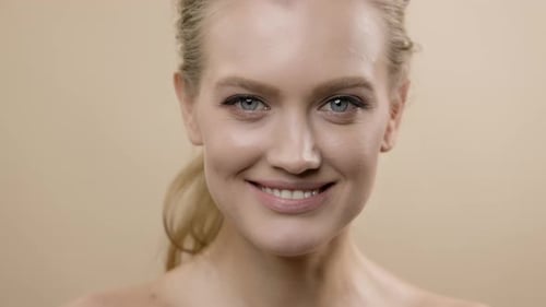 Woman Smiling and Winking in Bright Studio Close-up