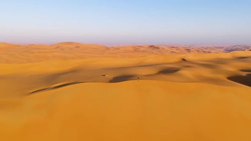 Aerial view of a man standing on the edge of dunes, U.A.E.