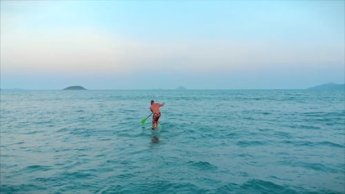 Surfer Is Waiting for His Wave. Surfer Flies on the Crest of a Wave, a Surfer Controls the Oar