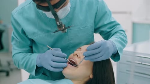 Dentist Examines Patient with Tools in Clinic
