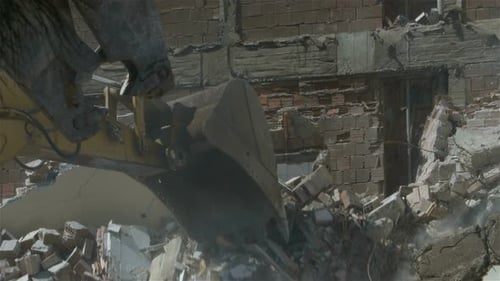Excavator Demolishing Building in Urban Setting