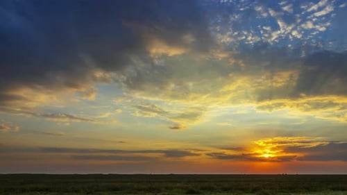 Vibrant Sunset Time-Lapse over Grassy Horizon