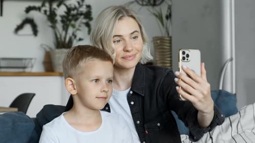 Woman and Child Using Phone Indoors