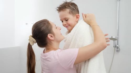 Mother and Child Embracing in Bathroom After Bath
