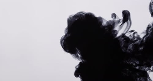 Abstract Black Ink Spreading Through a Milky Liquid