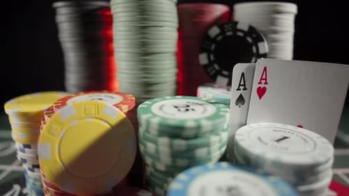 Casino Chips with Dice and Playing Cards on a Dark Table