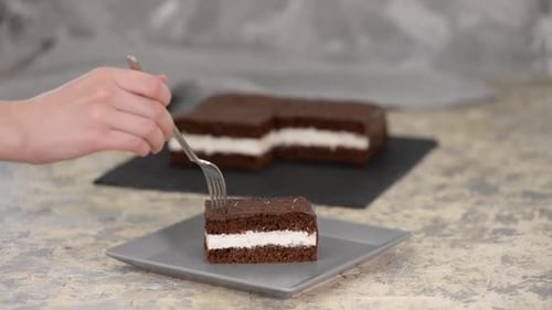 Chocolate Cake with White Filling Being Pierced by Fork