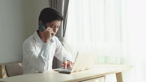 Young Adult Working From Home Answering Phone