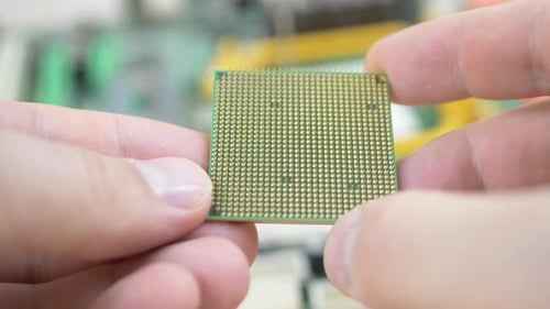 Man Holds Computer CPU Chip in Macro Shot