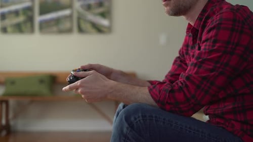 Man Relaxing and Playing Video Game at Home