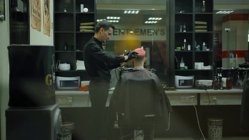 Barber Cuts Hair in Modern Barber Shop