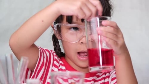 Child Doing Science Experiment with Red Liquid