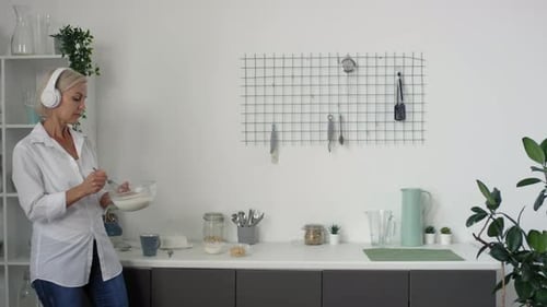 Woman Prepares Food at Home in Modern Kitchen