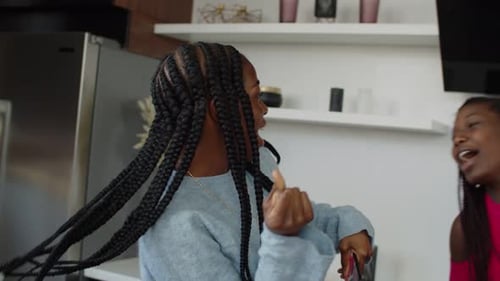 Three Friends Dancing and Singing in Kitchen