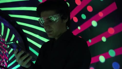 Young Adult Using Phone With Futuristic Lighting