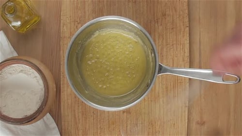 Preparing a Cooking Recipe on Wooden Table