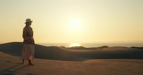 Female Traveller Walking on Sandy Beach
