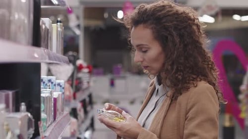 Woman Choosing Perfume In Beauty Shop