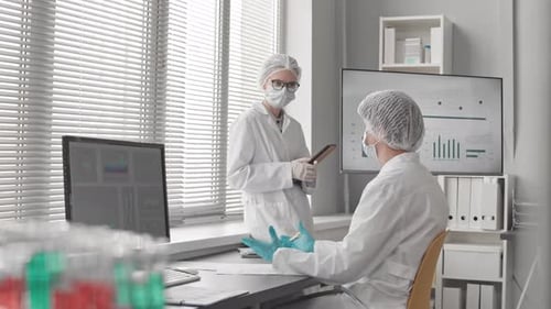 Medical Professionals Collaborating in a Bright Laboratory