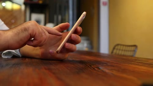 Using Smartphone Indoors on Wooden Table
