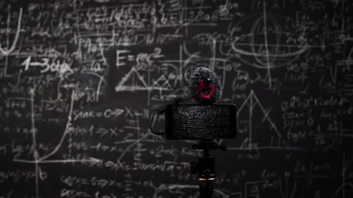 Phone on Tripod in Front of Blackboard