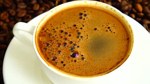 Steaming Cup of Coffee with Coffee Beans
