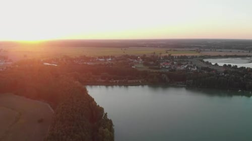 Magnificent Shot of Lake with Green Fields Surrounding It During Golden Hour