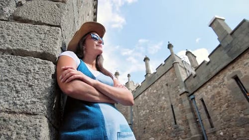 Pensive Woman Hiker Standing Leaning Stone Wall with Crossed Arms Touristic Architecture Place