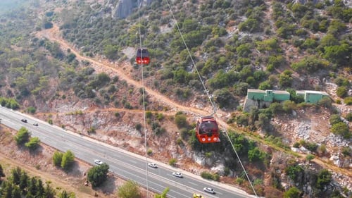 Close-up Flight Next To the Uphill Funicular with the Coast in the Background