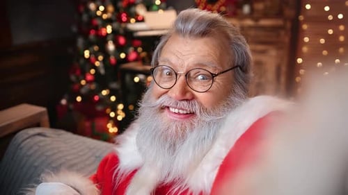 Cheerful Male Blogger in Santa Claus Costume Speaking Video Call