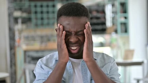 Portrait of Stressed Young African Man Having Headache