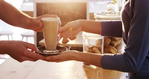 Serving Latte at Bright Coffee Shop