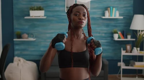 Athletic Woman Exercising with Dumbbells at Home