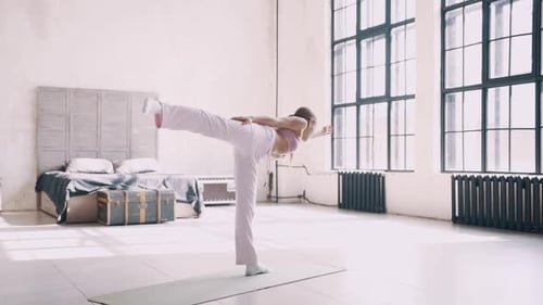 Woman Doing Balancing Yoga Pose Indoors