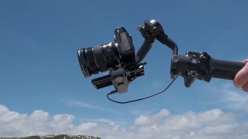 Camera on a Gimbal Against Blue Sky
