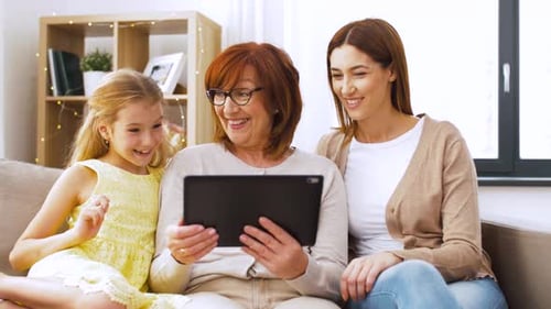 Happy Family Using Tablet on Couch at Home