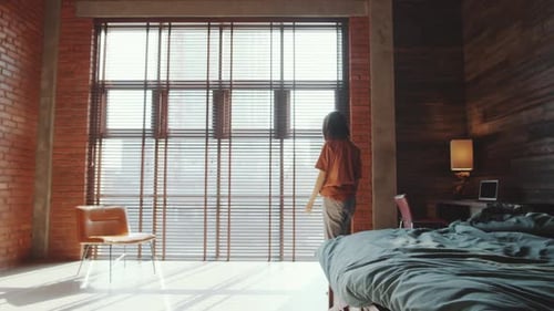 Woman Stretching Near Window in Bright, Modern Apartment